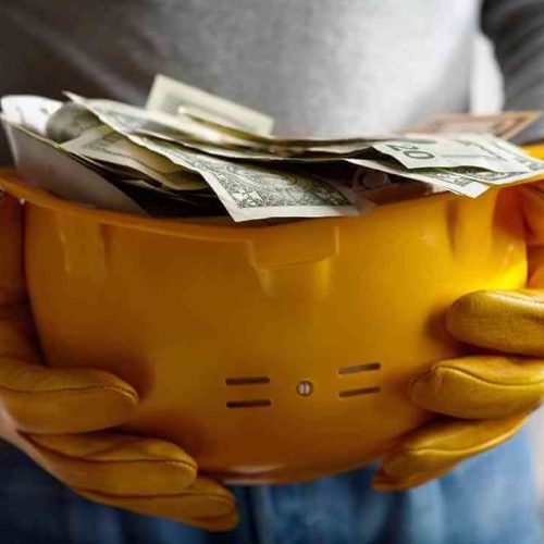 pile-of-money-in-hard-hat Construction Accounting Image 1